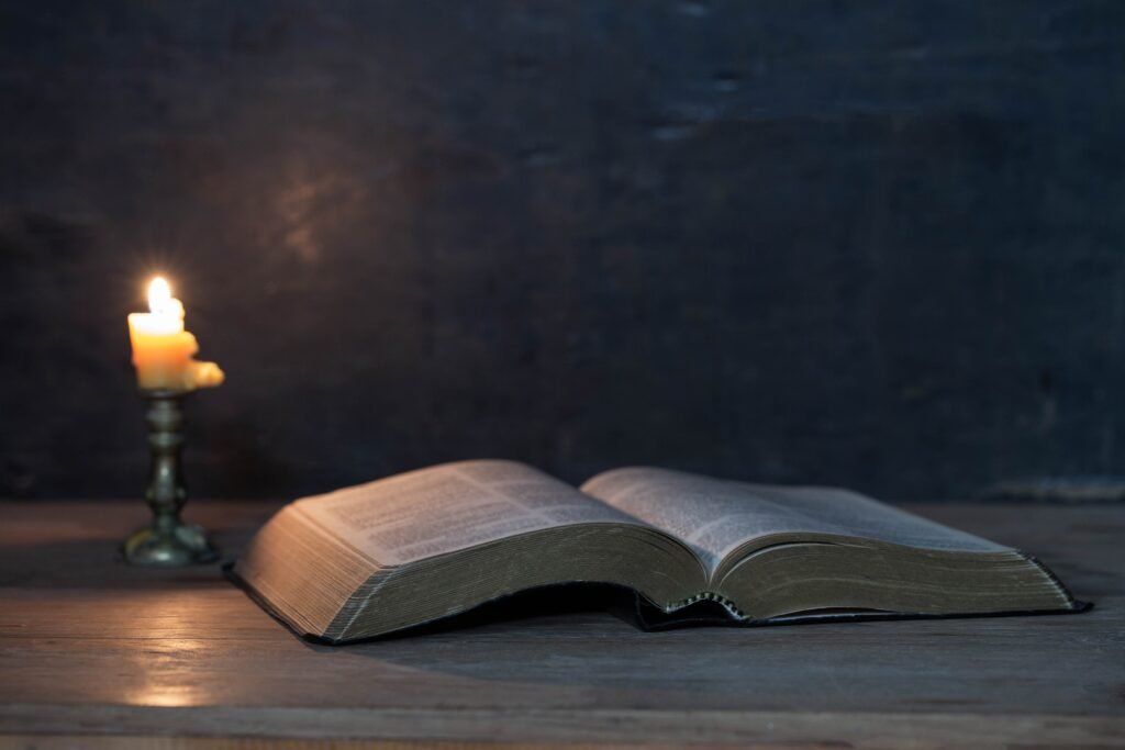 Scriptures and candles on a wooden table, golden background, beautiful, religious concepts